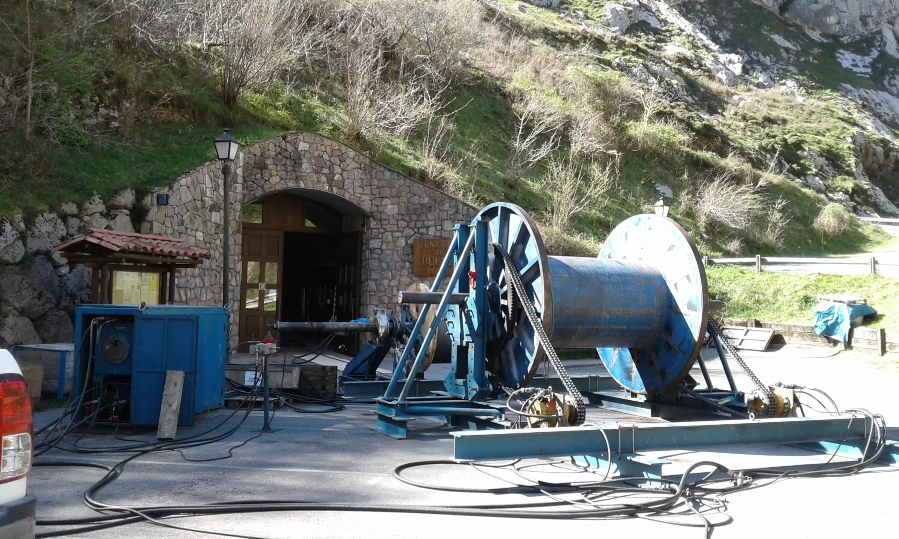 Bobina y equipos junto a la entrada de piedra de la estación